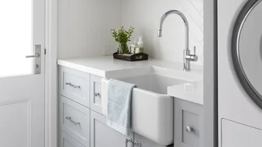 Classic white and blue laundry with chrome tapware.