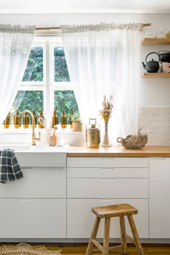 White and timber country style kitchen with farmhouse sink.