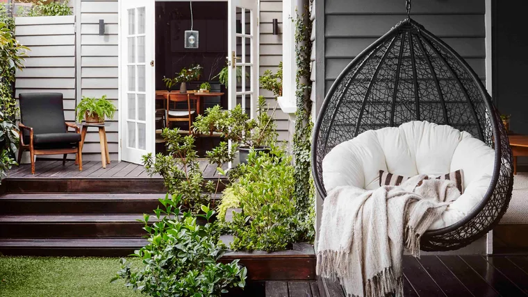 Backyard with deck and hanging egg chair