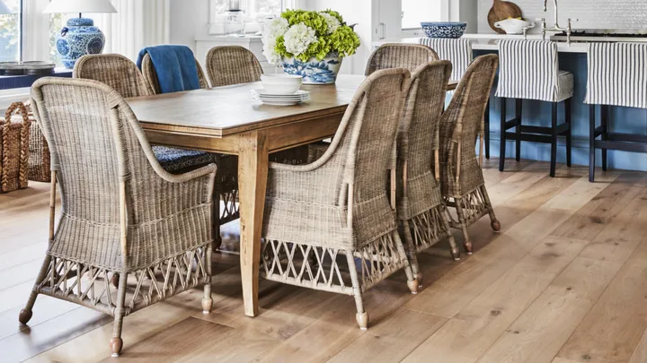 The dining room in a Bowral cottage with woven chairs, blinds and pendant.