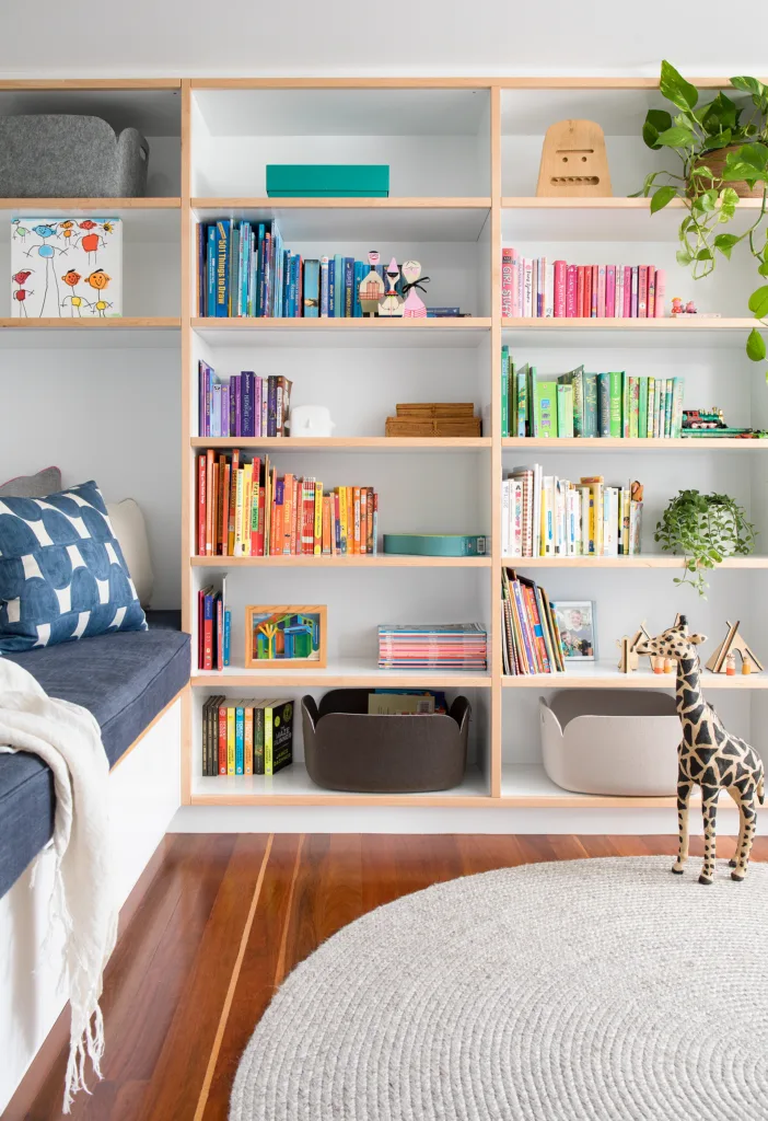 Colourful kids room bookcase with plants on shelves