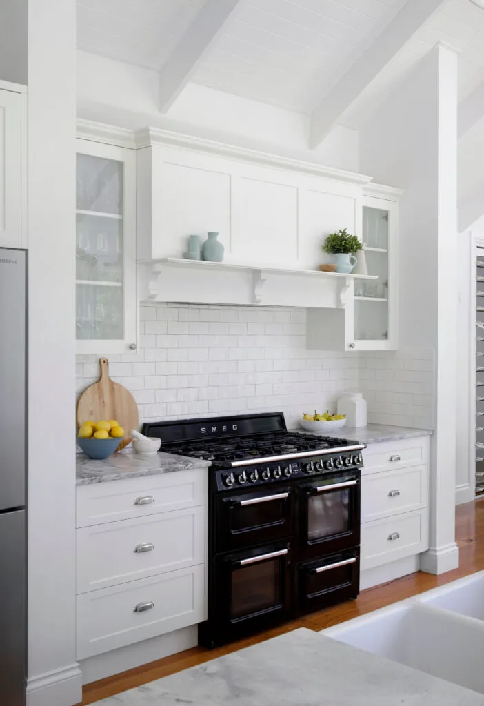 White modern kitchen with black freestanding oven