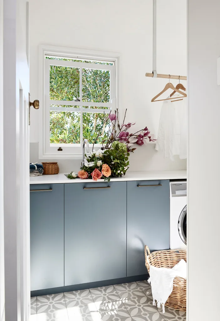 Blue and white laundry with hanging rail above benchtop.