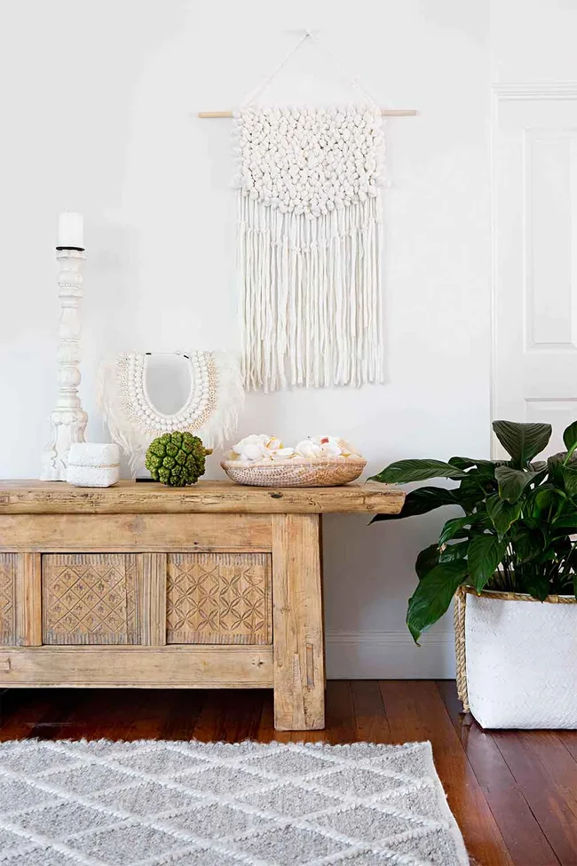 Coastal style entrance hall with vintage timber sideboard and collected shells