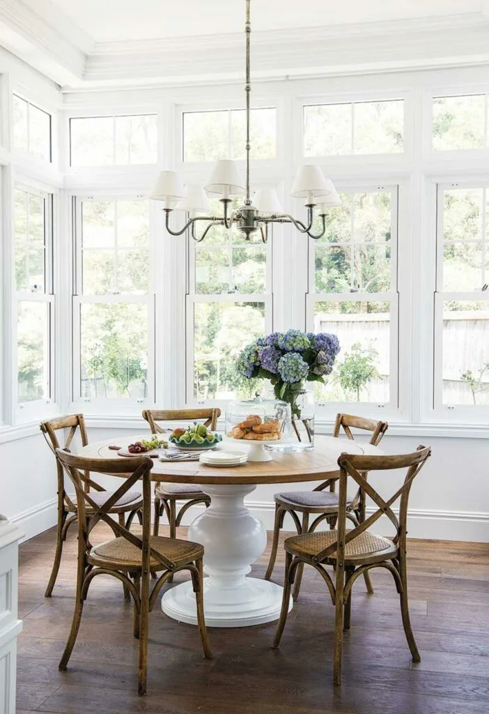 Hamptons style breakfast nook with round dining table.