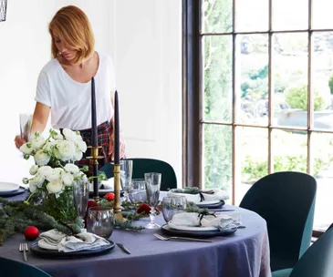 Woman decorating Christmas table
