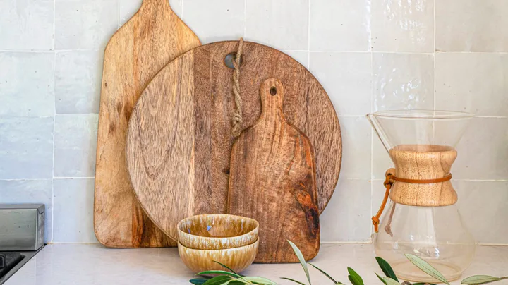 wooden chopping boards arranged by size on a kitchen benchtop