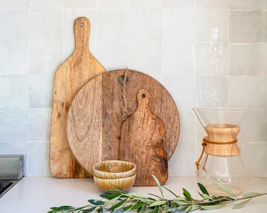 wooden chopping boards arranged by size on a kitchen benchtop