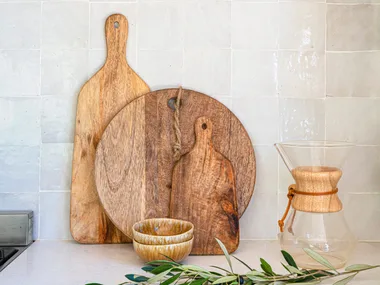 wooden chopping boards arranged by size on a kitchen benchtop
