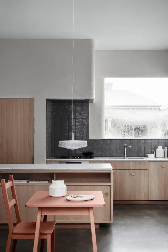 Neutral kitchen with pink dining table