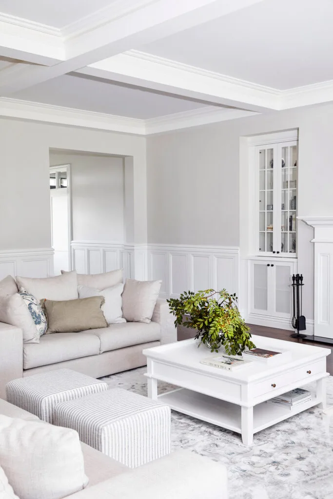 White and beige Hamptons style living room with coffered ceiling.