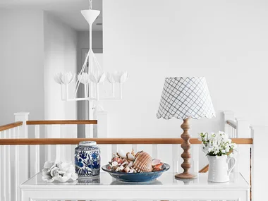 A cordless table lamp is part of the decor.