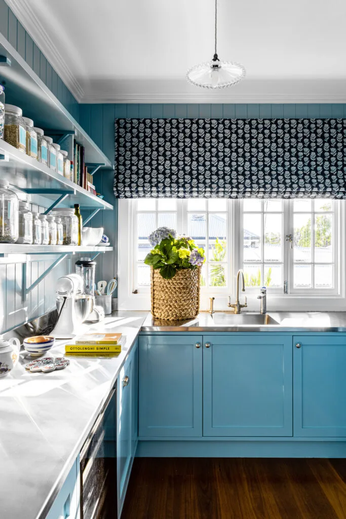 butler's pantry with stainless steel benchtops, open shelving and blue painted cabinetry