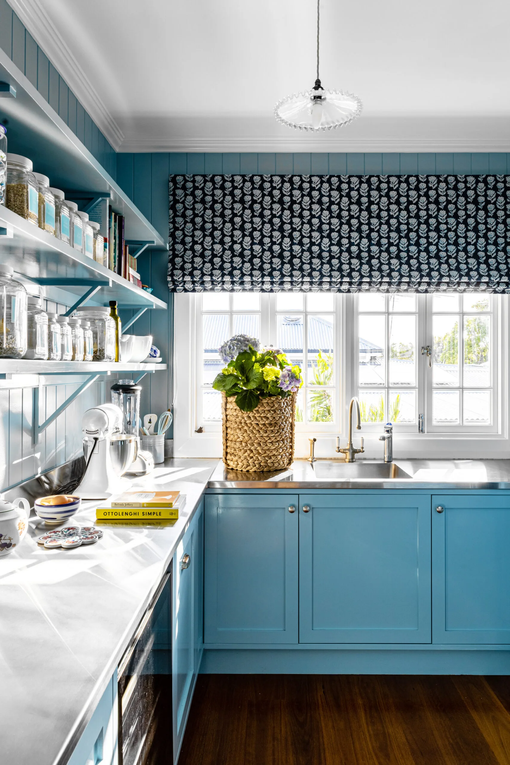 blue-coloured butler's kitchen pantry with stainless steel benchtops, open shelving and blue painted cabinetry