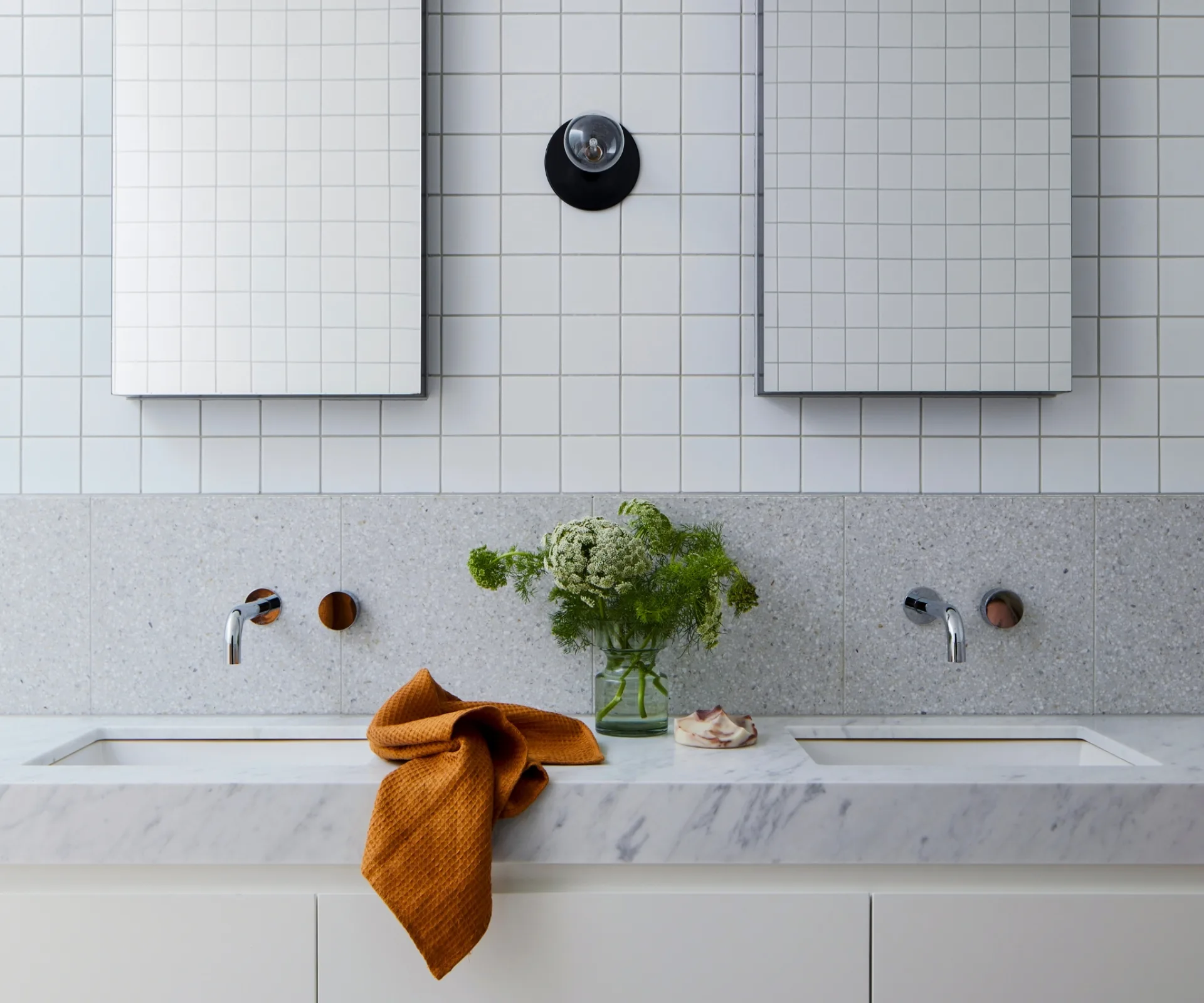 Double vanity with inset sinks and square tiled splashback