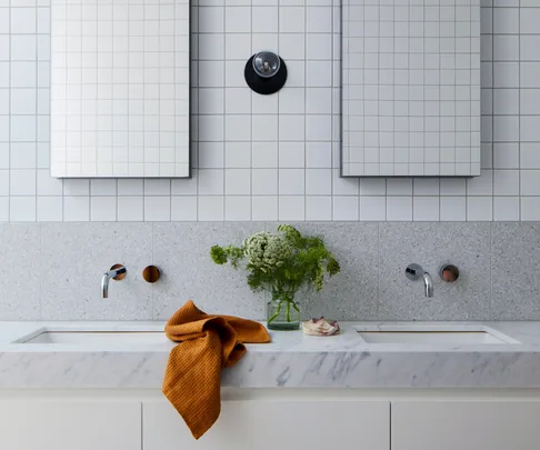 Double vanity with inset sinks and square tiled splashback