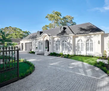 Hamptons style white home exterior with arched windows