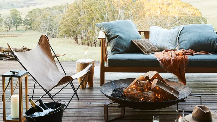 Timber deck with outdoor furniture and glowing fire pit