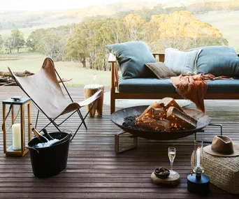 Timber deck with outdoor furniture and glowing fire pit