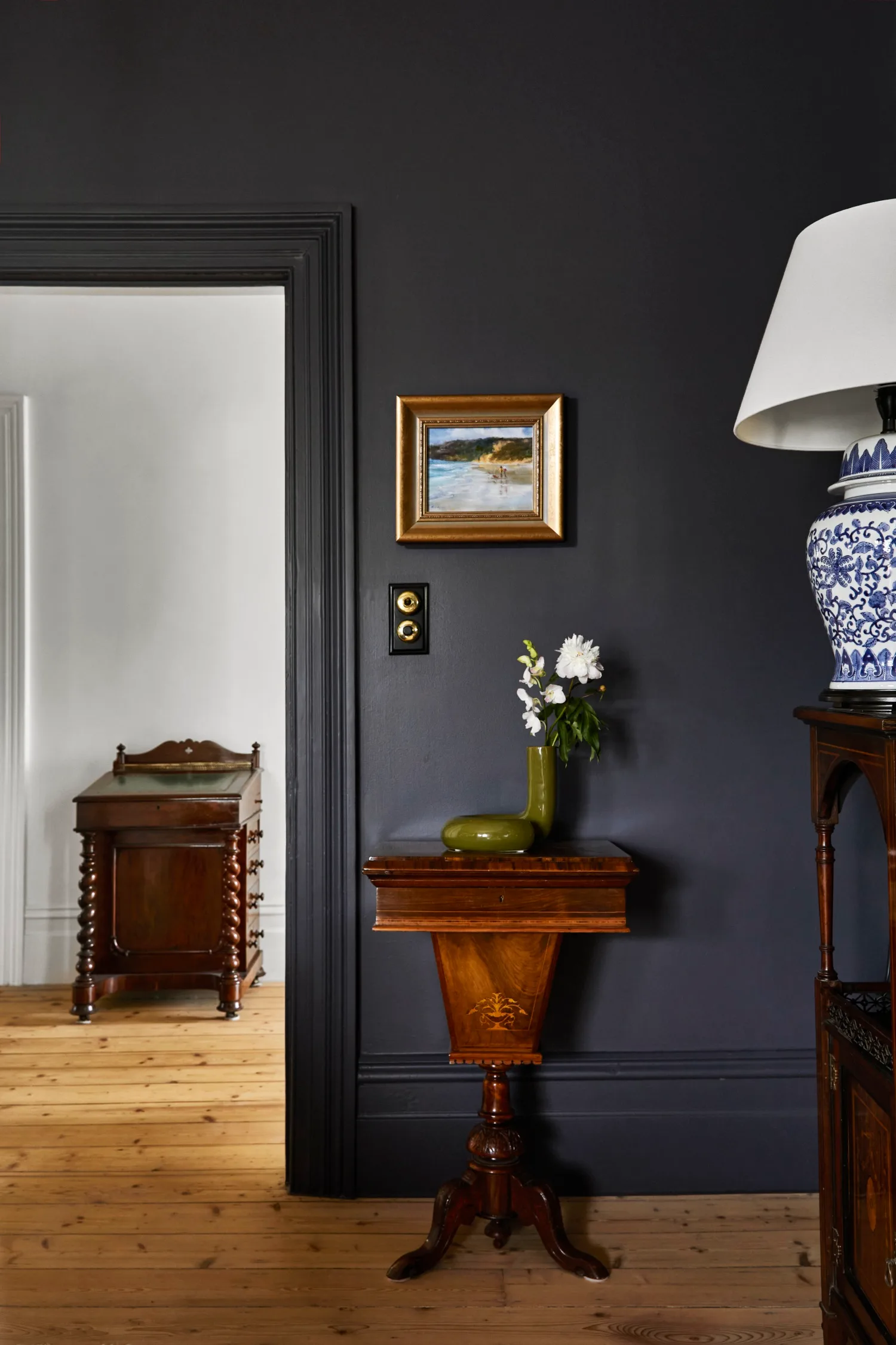 Black living room walls with wooden floors