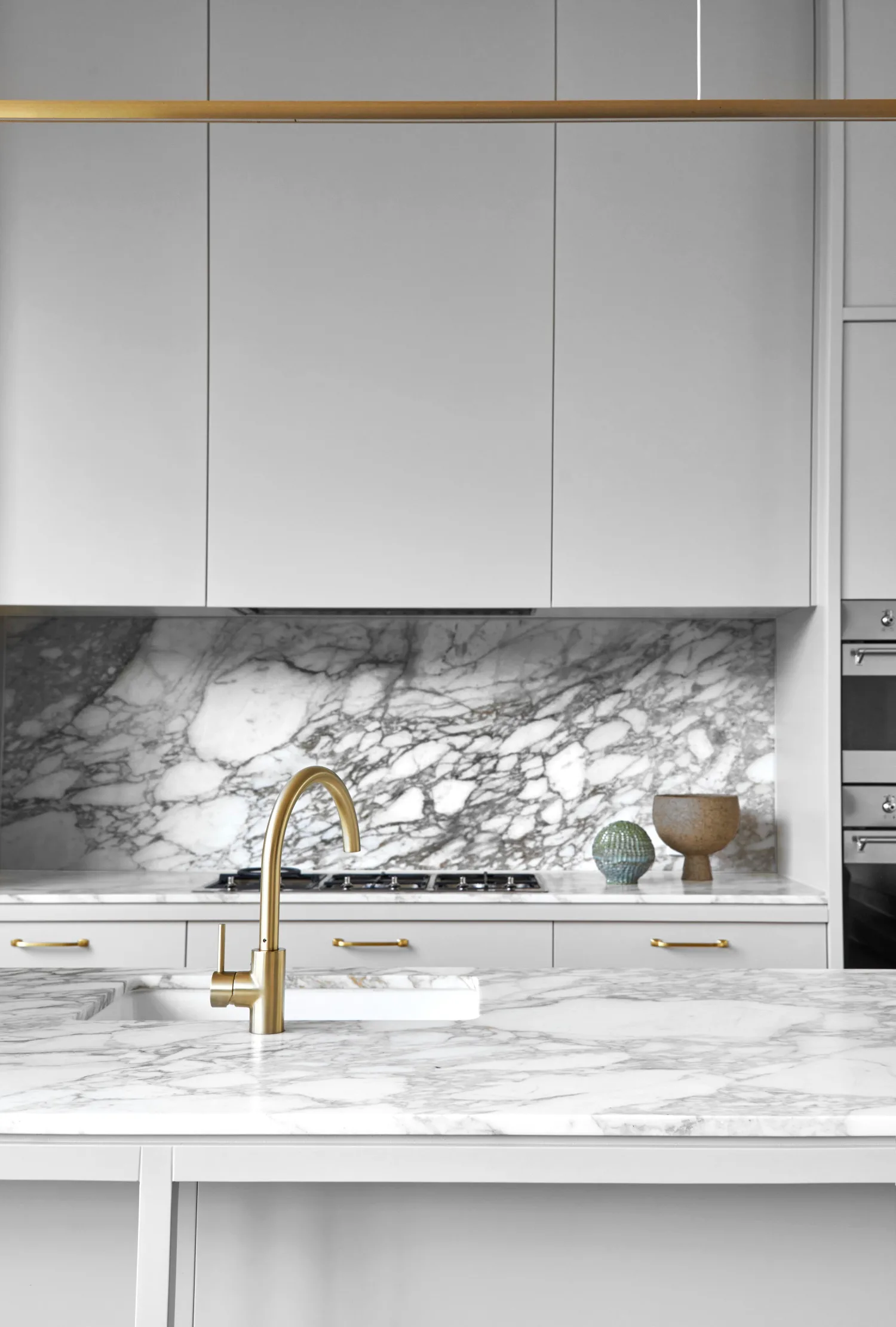 grey kitchen cabinets with marble splashback