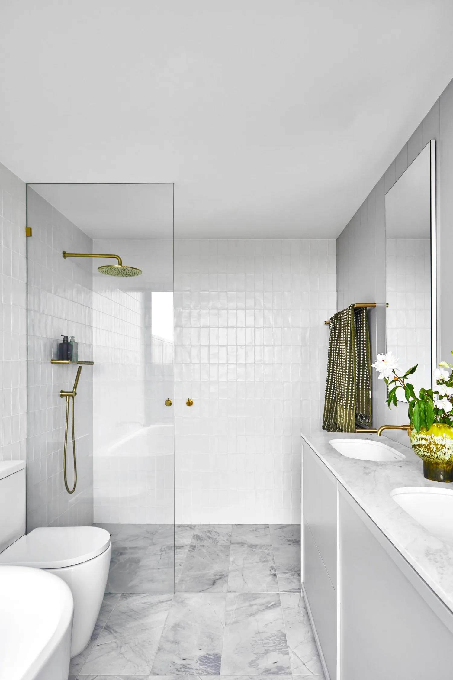 ensuite with white wall tiles and grey marble floor
