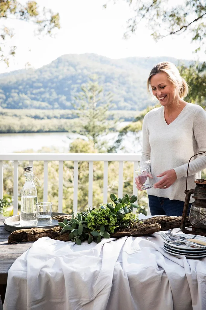 Tara Dennis next to table with suculent centrepiece in it