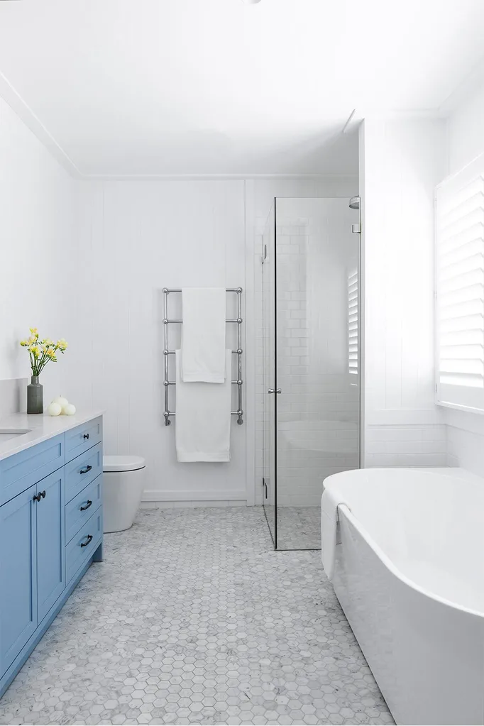 Marble and white bathroom with blue vanity