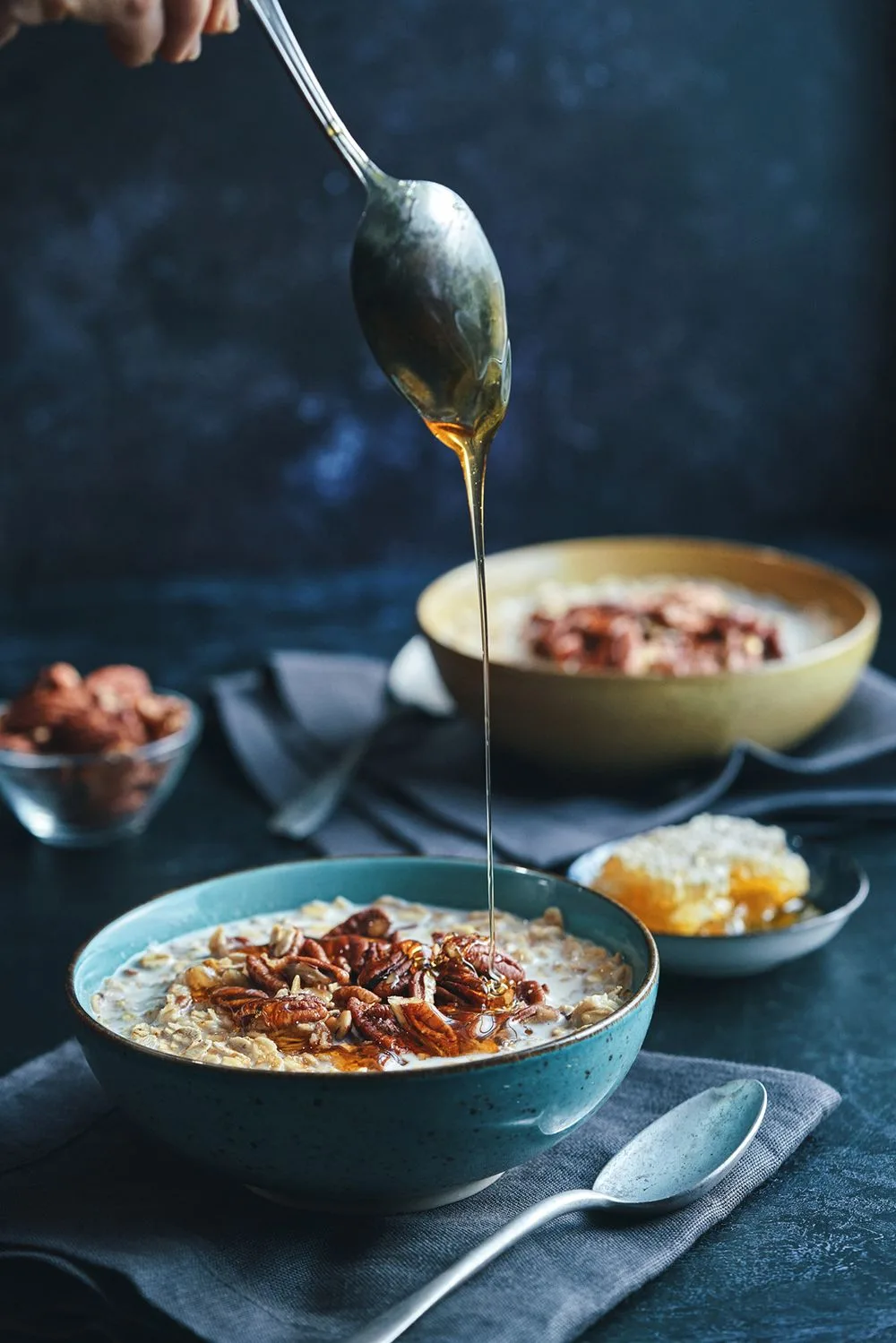 Bowl of porridge being drizzled with honey