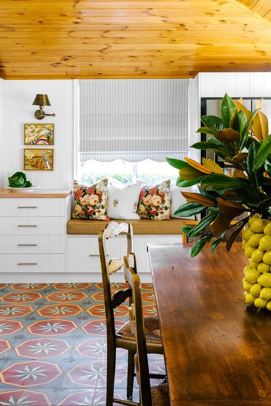 Colourful cottage kitchen with upholstered window bench seat