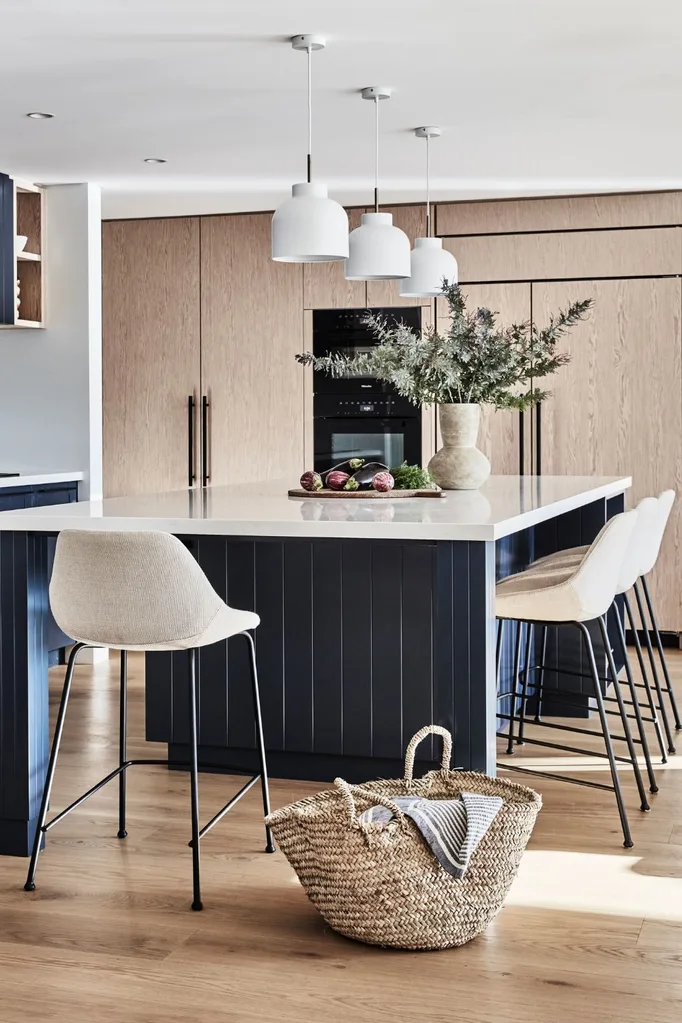 Freedom pendant lights with navy blue kitchen island