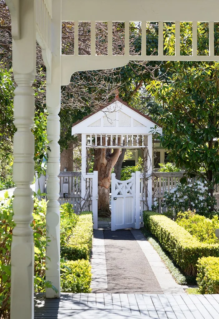 Front garden with hedge and white fence