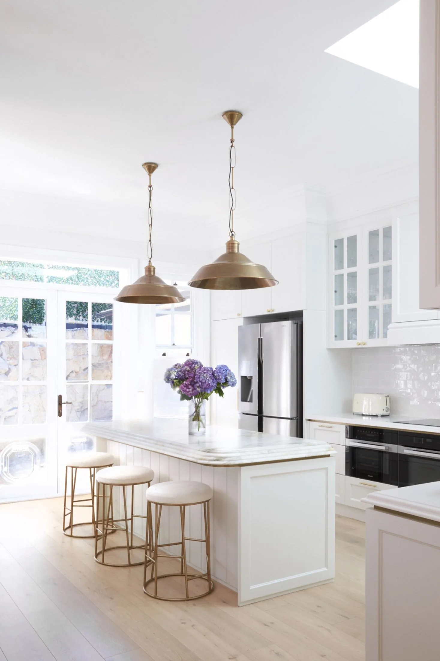 White marble kitchen island inspired by the French provincial aesthetic