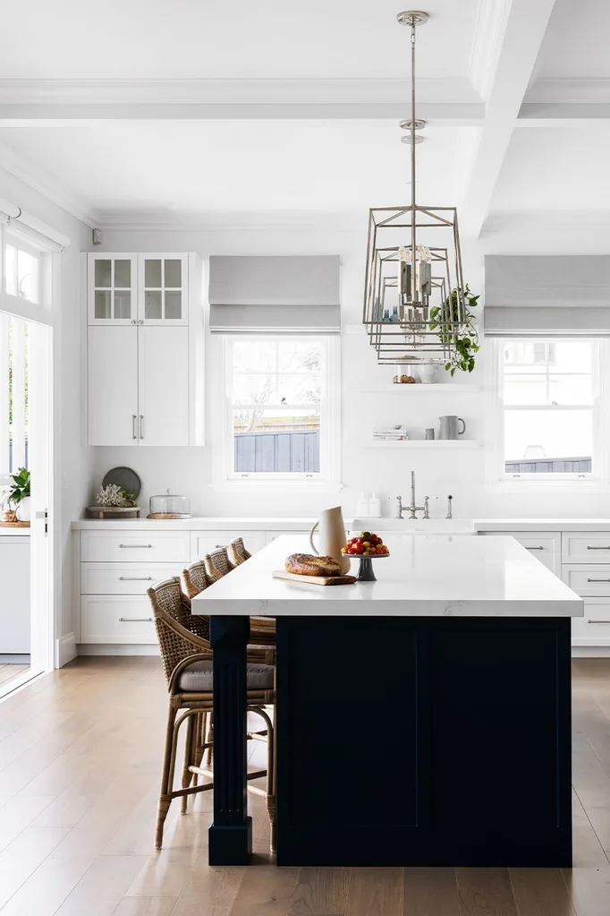 Hamptons-style white and black kitchen with an island bench