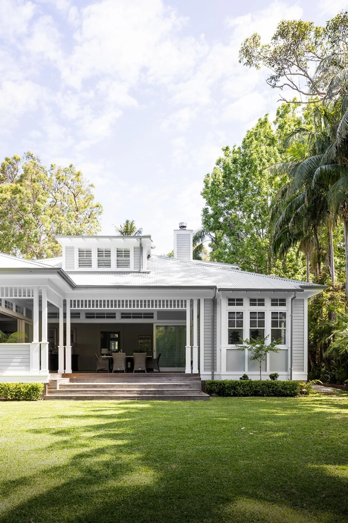 Hamptons style home with large backyard featuring lawn