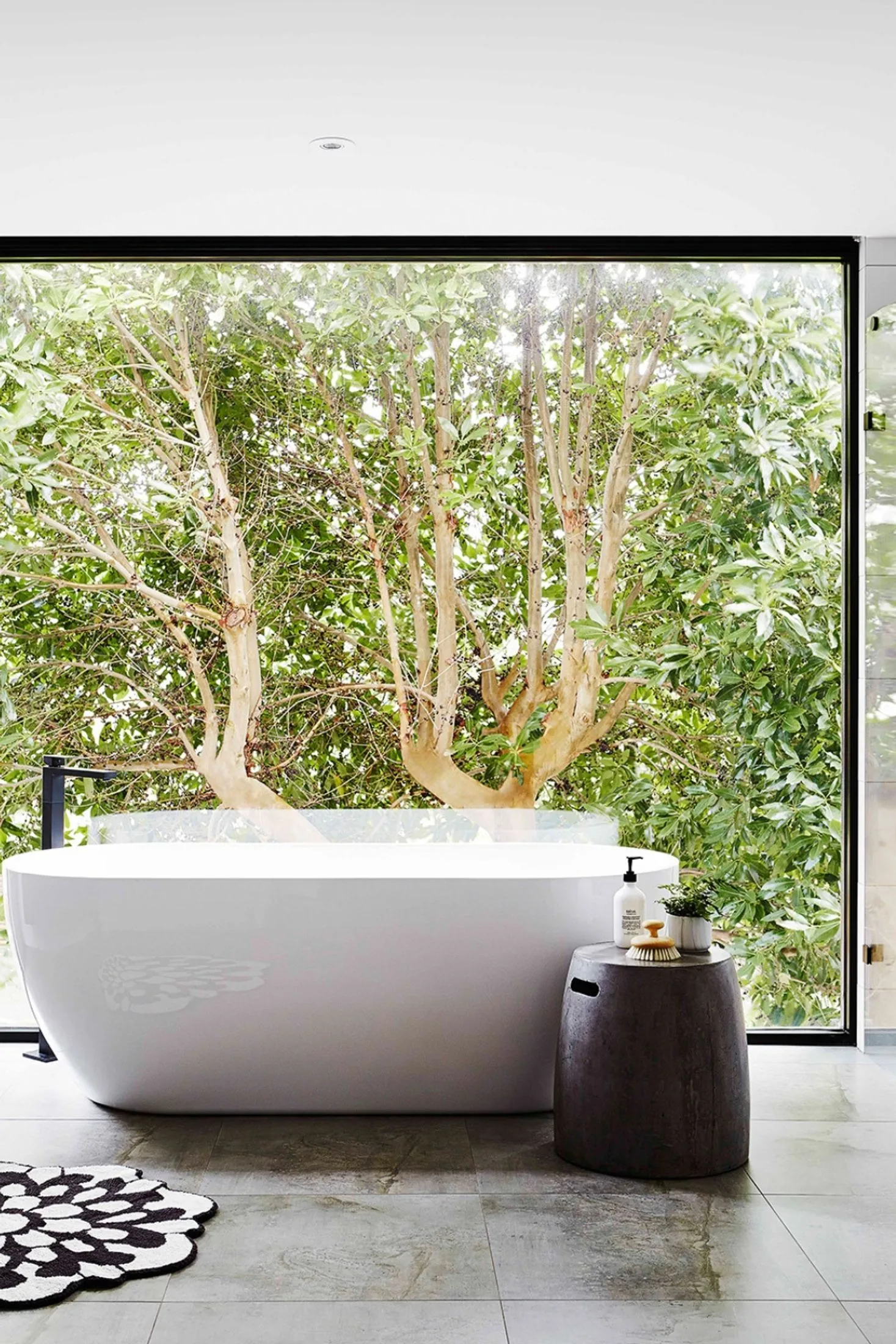 Modern bathroom with a freestanding bath in front of a picture window