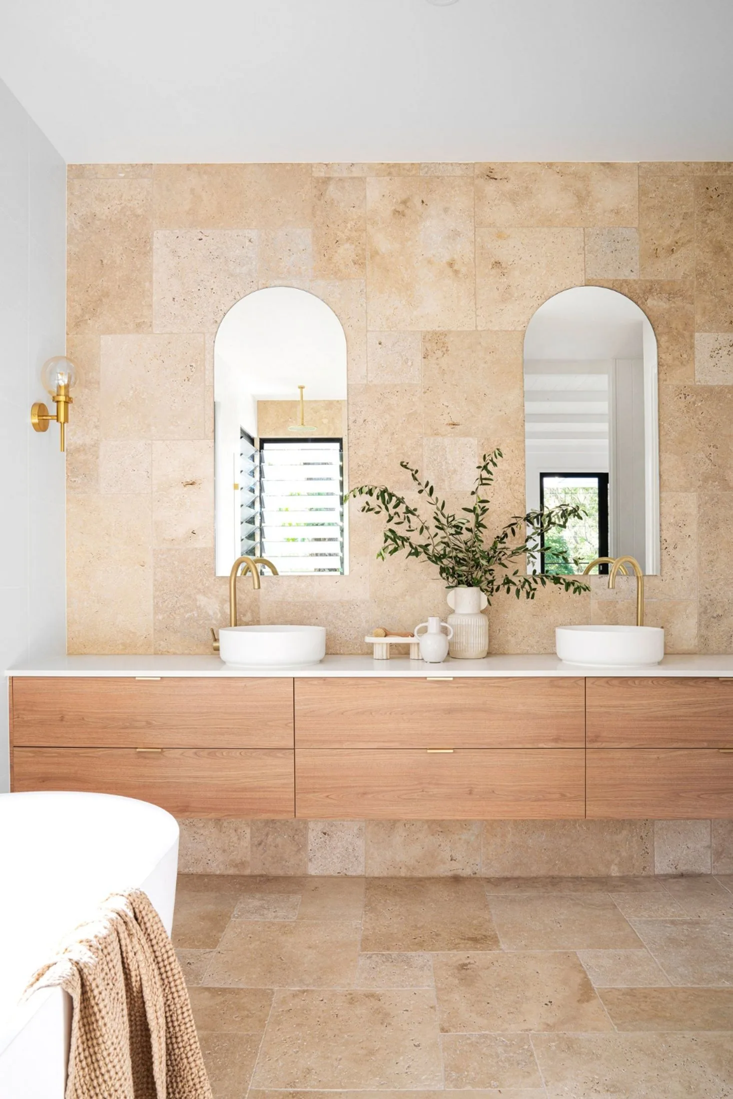 Modern coastal bathroom with sandy coloured tiles and a double vanity