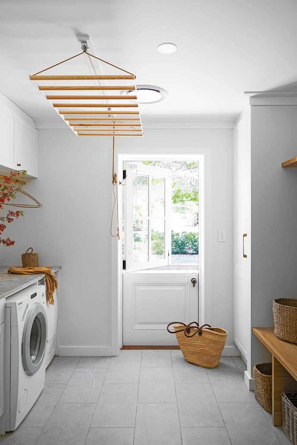 Combined laundry and mudroom with dutch door