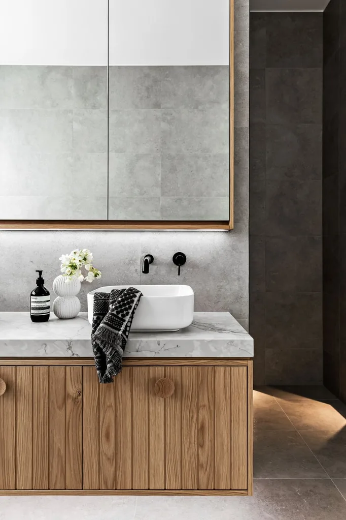 Modern luxury bathroom with American oak vanity and grey stone benchtop and tiles