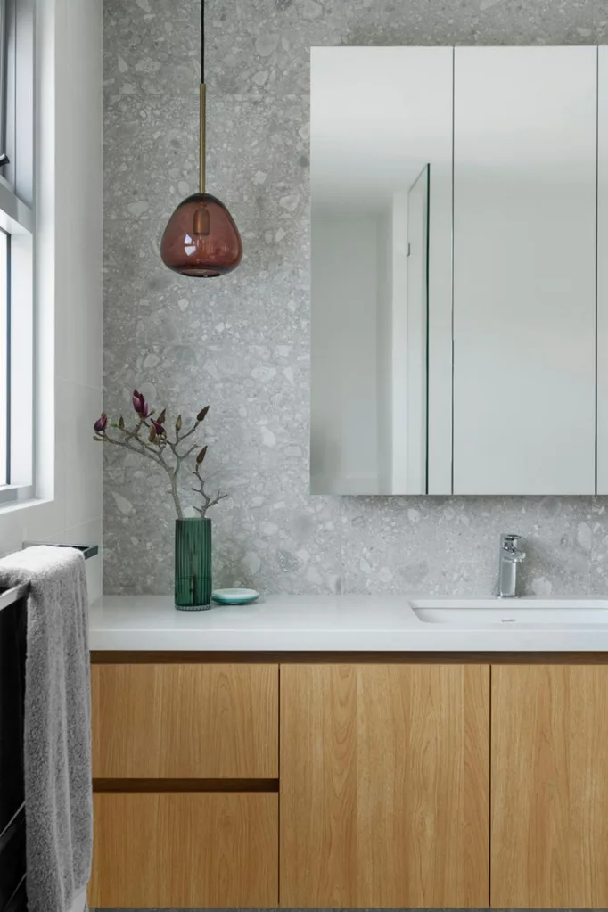 Timber and grey luxury bathroom with coloured pendant light