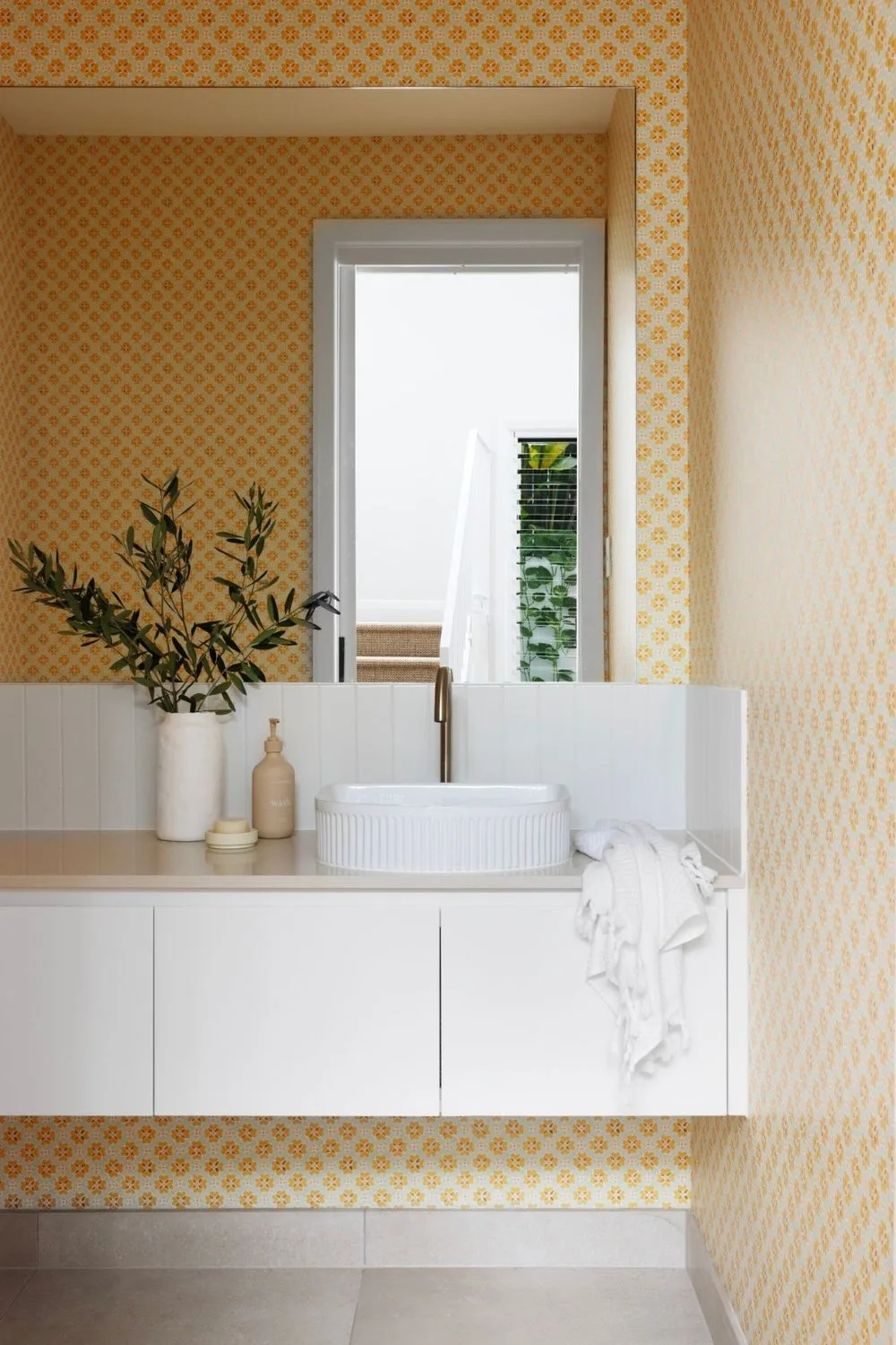 Luxury bathroom with yellow wallpaper