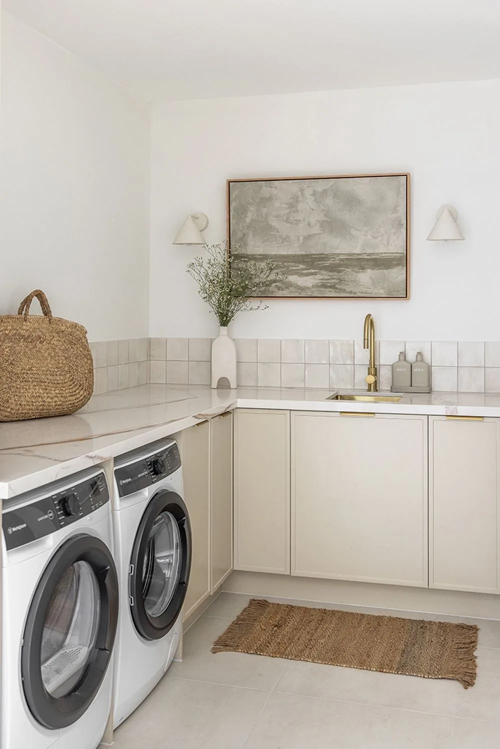 Calming, coastal style laundry designed by Andy and Deb featuring a handmade tile splashback