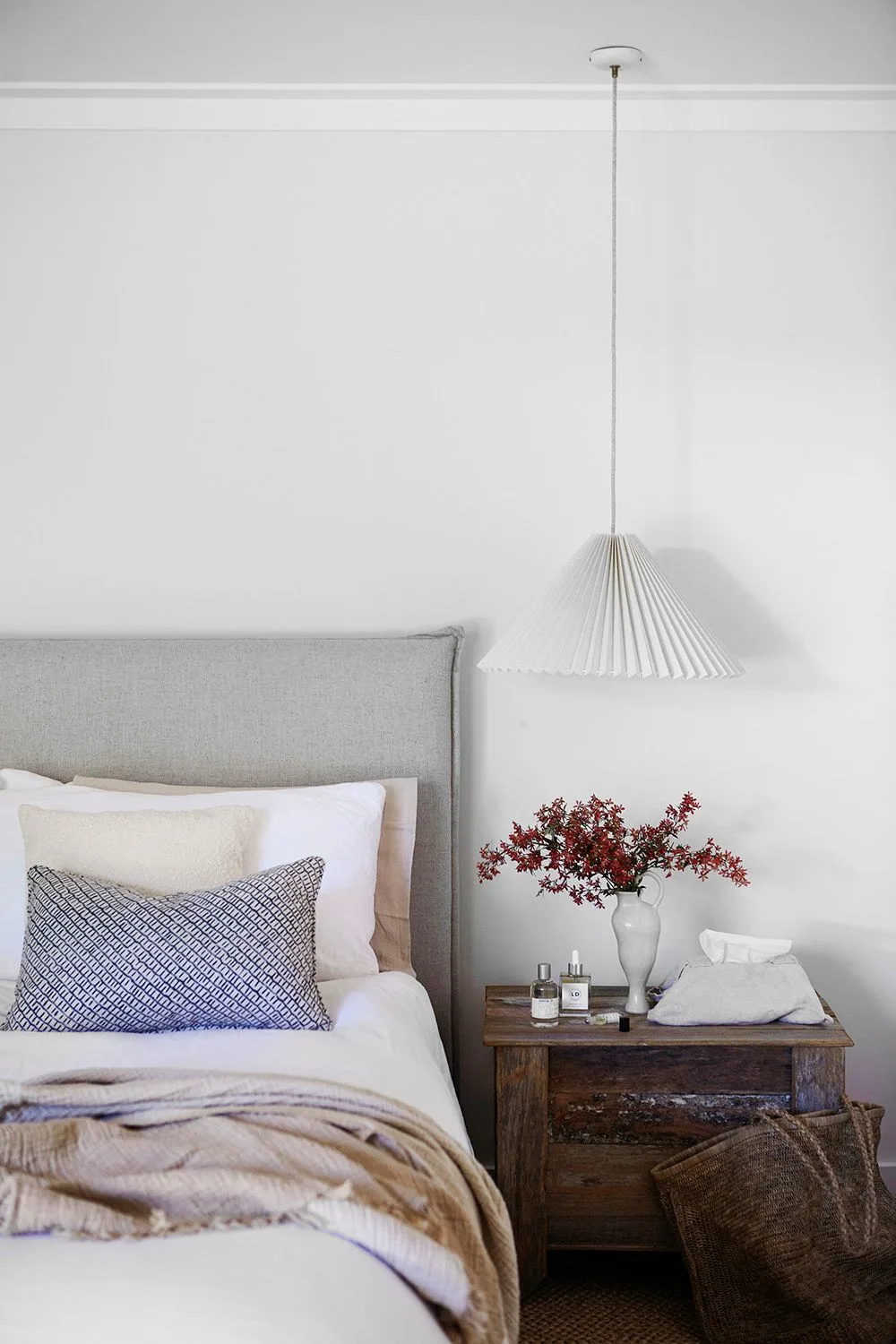 White and timber bedroom with pleated pendant lamp