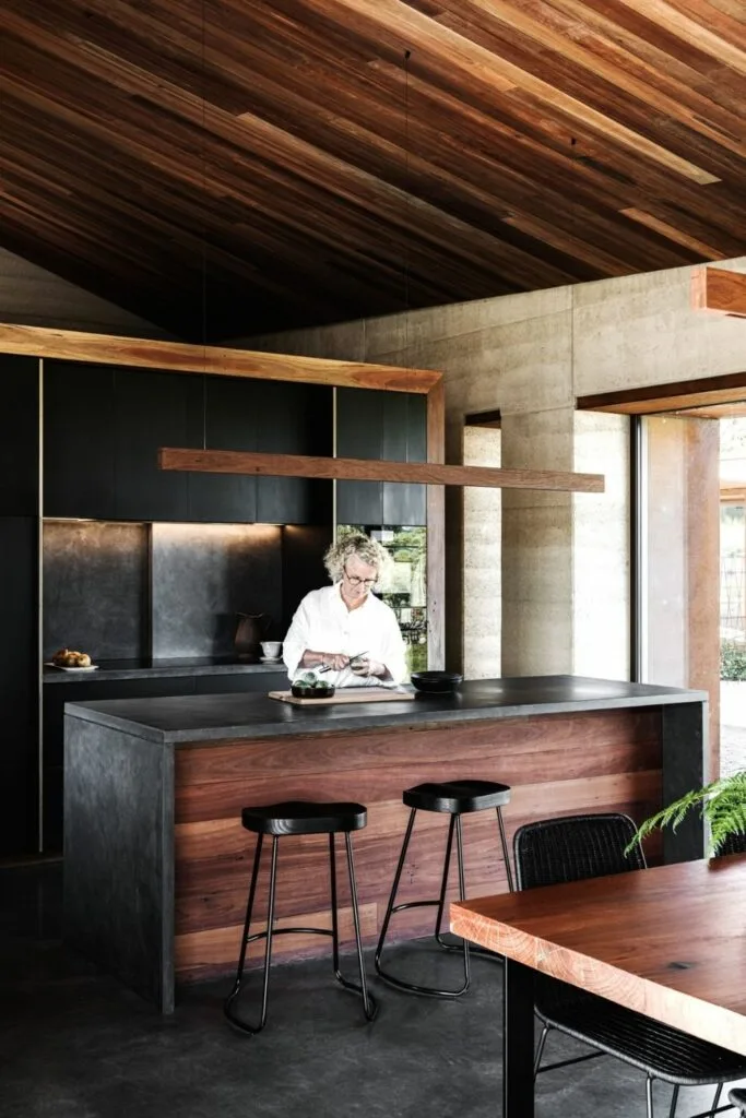 Timber and concrete kitchen with wooden horizontal pendant light