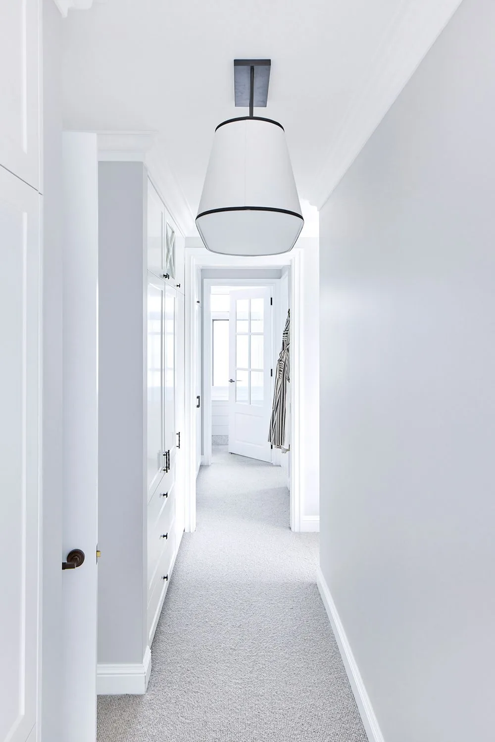 White and grey Hamptons style hallway with carpet