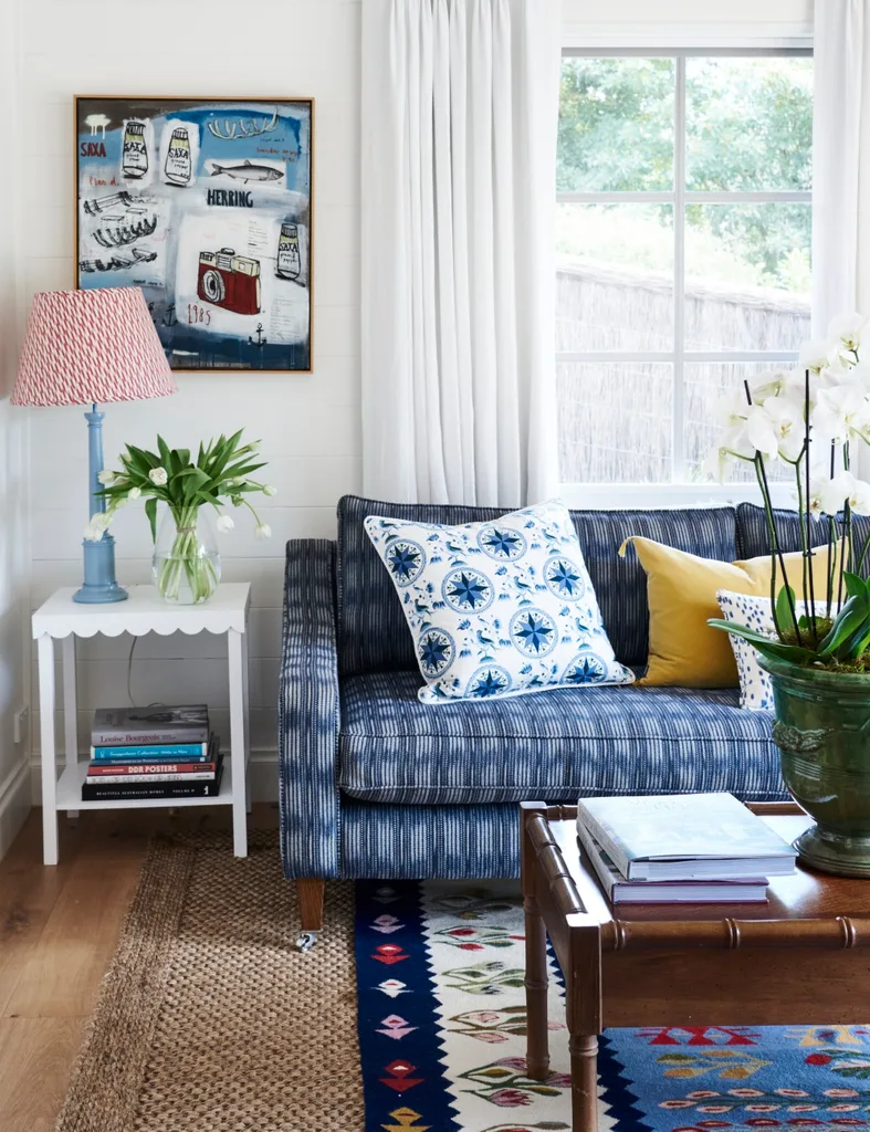 Light living room with blue and white sofa and sisal rug