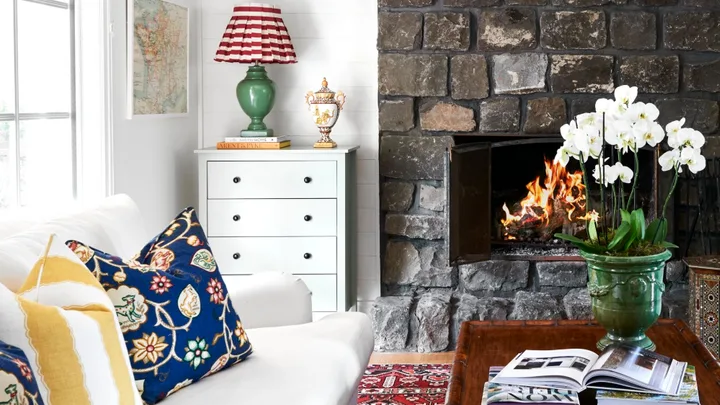 Light living room with white sofa and stone fireplace