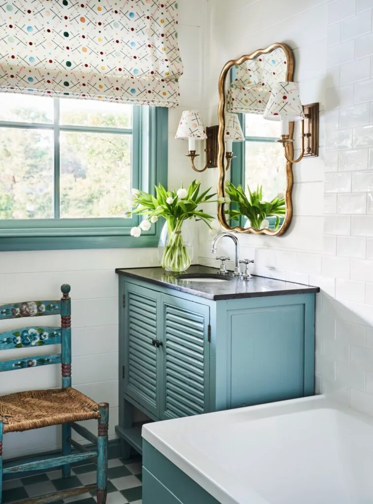 Family bathroom with inset bathtub and blue painted bathroom vanity