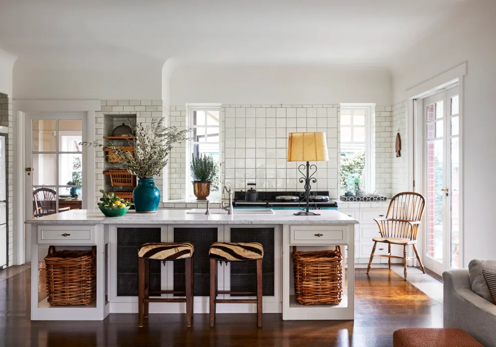 Cottage kitchen with square white wall tiles and island bench with basket storage