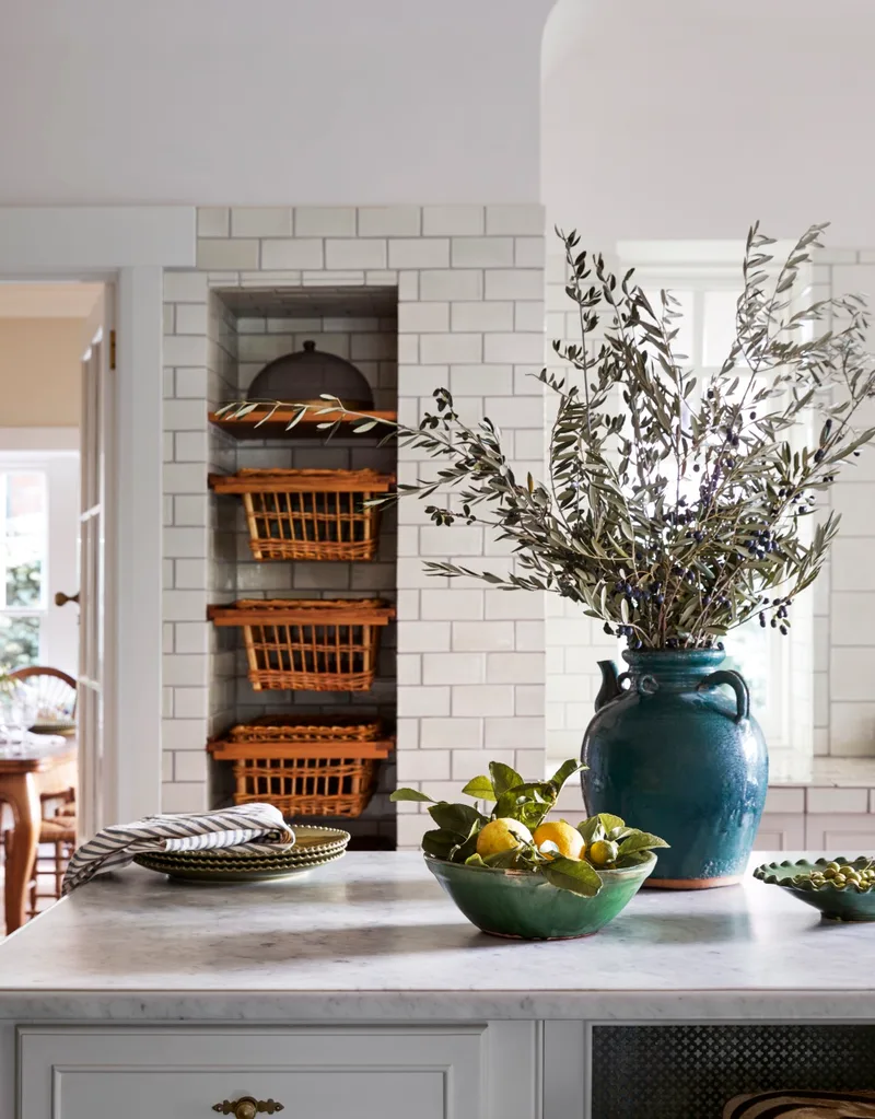 Cottage kitchen with square white wall tiles and island bench with basket storage
